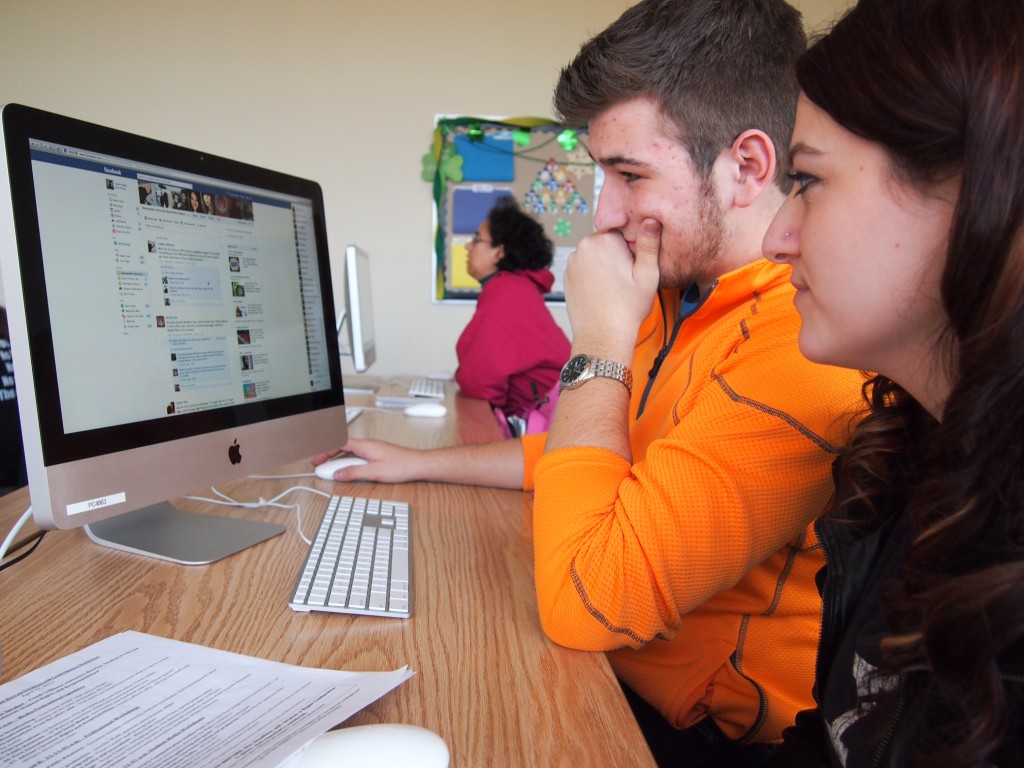 Afton Fonzo, social media editor, and Justin Wahy, multimedia editor, review content requests during a Wood Word editorial meeting. (Photo: Lindsey Wotanis)