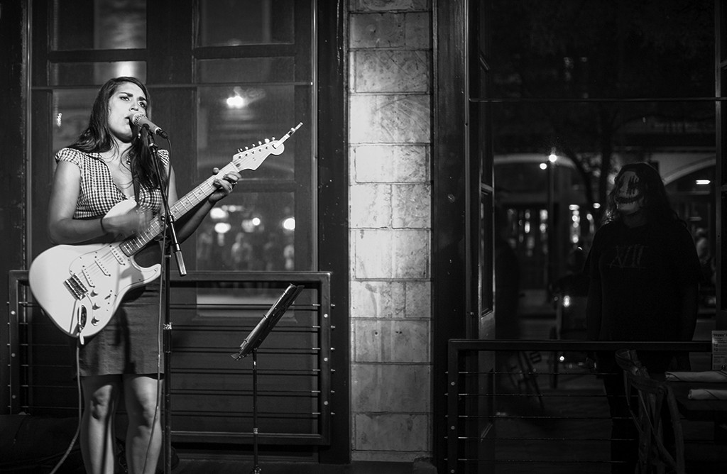 FIRST PLACE: Taylor Slifko Austin Peay State University (Jake Lowary, adviser) Aspiring musician and Austin, Texas native, Katy Starr performs at local venue while attracting an obscure fan from Sixth Street Oct. 30. When the stranger appeared in the window Starr was startled but kept playing “Hotel Yorba” by The White Stripes. “I had always grown up playing but it wasn’t until recently I figured out I wanted to do music… It’s my passion," Starr said.