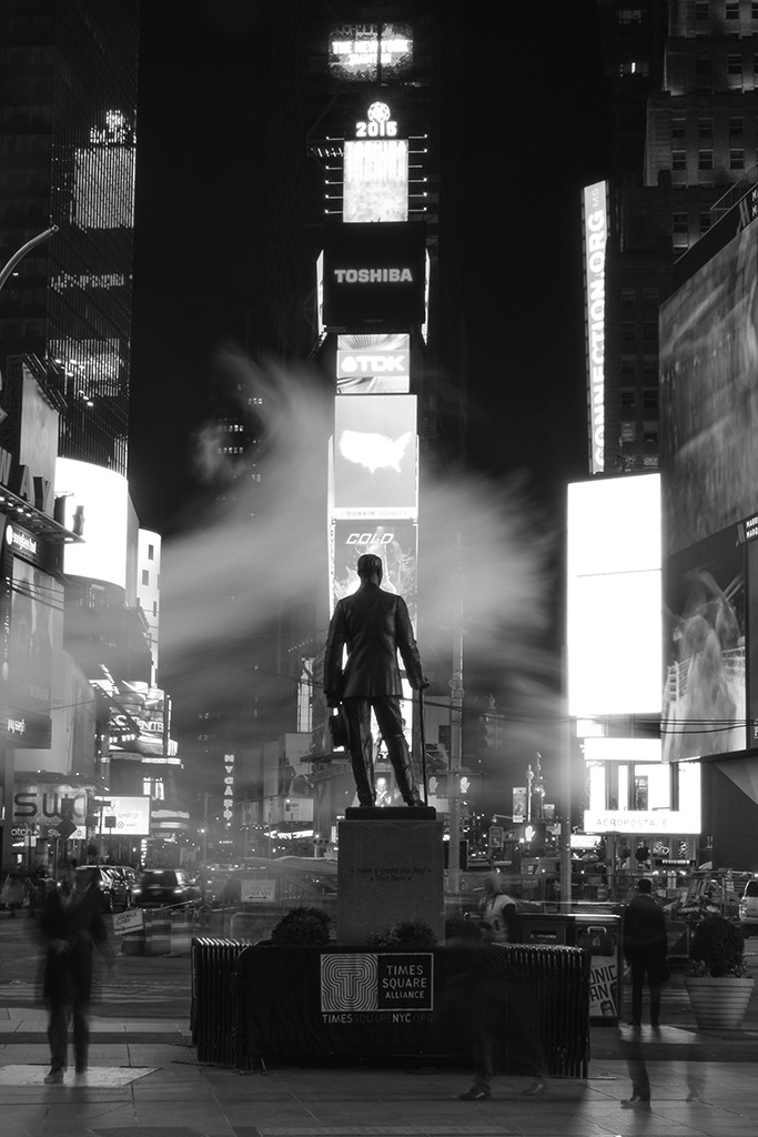 FIRST PLACE, SPRING 2015: Adam Ernesto Fuentes, Mt. San Antonio College (Toni Albertson, adviser) — Commuters and tourists alike trail across a statue of George M. Cohan, the father of American musical comedy.The city lights and subway haze transform Time Square into a Broadway stage.