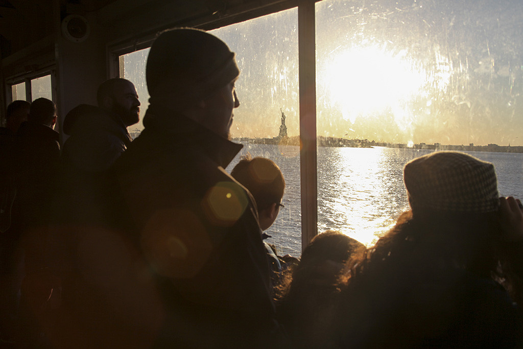 SECOND PLACE: Frank Ladra, San Francisco State University (Rachele Kanigel, adviser) — Passengers of the Staten Island Ferry watch the sun set behind the Statue of Liberty in New York City on Thursday, March 12, 2015. Designed by French artist Frederic Auguste Bartholdi, the statue has been a symbol of freedom since 1886.