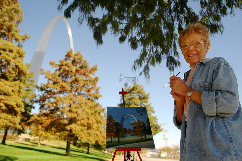 FIRST PLACE: Photo by Annabelle Ombac, Virginia Tech University (Kelly Wolff, adviser) — A local woman paints a picture of famous St. Louis Arch on the Mississippi River bank.