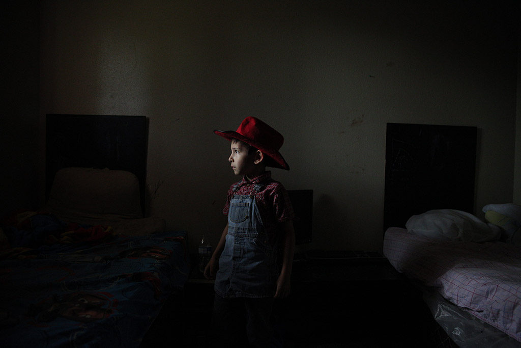 Caiden Contreras, who has autism, stands for a portrait in the room he shares with three of his brothers at his home in San Antonio, Texas, U.S. on May 27, 2015. His parents are both unemployed and living off of his and some of his siblings' disability checks, as well as several other forms of financial assistance from the government. His mother Sandra Contreras homeschools Caiden and four of his seven siblings at their home.