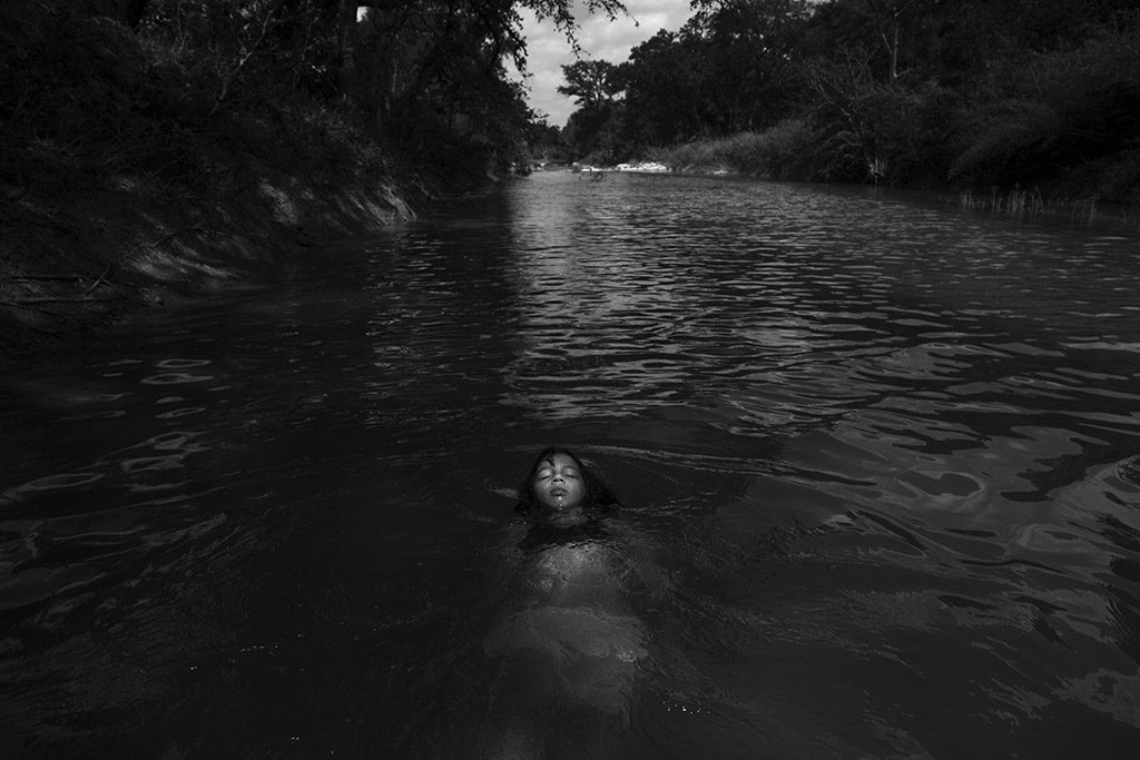 Serenity Bamberger floats in the Little Blanco River along their property on August 18, 2015 in Blanco, Texas. Three months prior, over Memorial Day, the same river flooded their home and business destroying the majority of the family's belongings and source of income. The Memorial Day weekend flooding, which affected Texas and Oklahoma, killed 24 people according to The Associated Press. Three of those deaths occurred along the Blanco River of which the Little Blanco River is a direct tributary. Despite the toll the river has taken, Bertha Rivera, Serenity's grandmother, said, "The river bed was dry for years, so now that the water is here I tell the girls to take advantage of it all that they can."