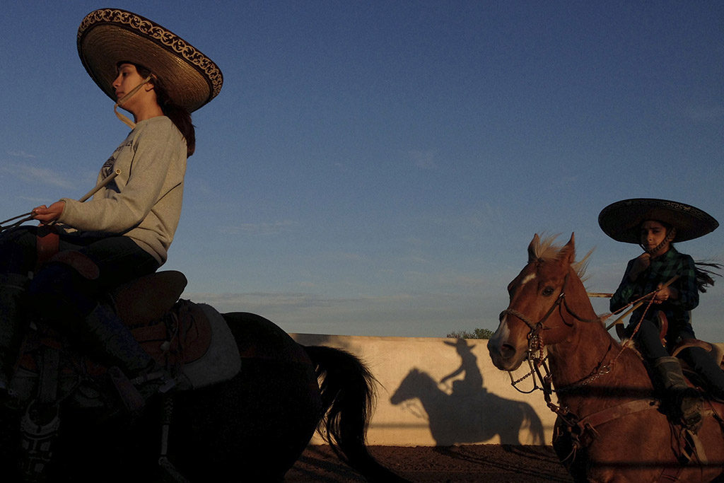 Caterina Ozuna and Miriam Alejandra Montecillos warm up before practicing their routine for Pre-Estatal at El Rancho Unico in Atascosa, Texas, U.S. on March 26, 2015. "You feel the nerves the moment you go in," Ozuna said.